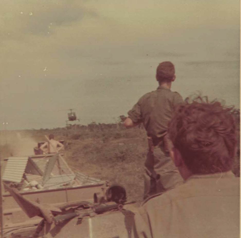 This pic shows a very low flying helicopter.  We are on an APC convoy.  Year is 1969 but can’t recall just where.  Somewhere in Phuoc Tuy Province